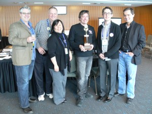 2014 GOHCBC judging panel with winning brewer James Grant (The Blue Elephant) holding the coveted ‘Bottomless Cup’ in Niagara Falls during the OFVC – L-R: Jason Deveau, Jeff Stevens, Laura Takata, James Laurent, Al Sutherland, and Michael Ligas